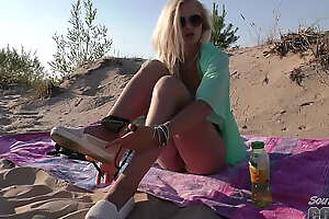hot blonde undisguised to hand the beach