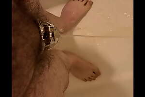 Fag pissing in Chastity