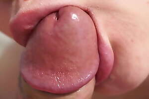 Close-up blowjob with cum encircling mouth and swallowing